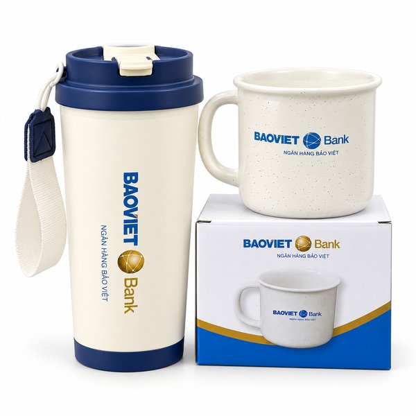 An insulated tumbler and ceramic mug set printed with the BAOVIET Bank logo, in matching branded packaging — an actual bank client gift produced by Now Creative Gifts.