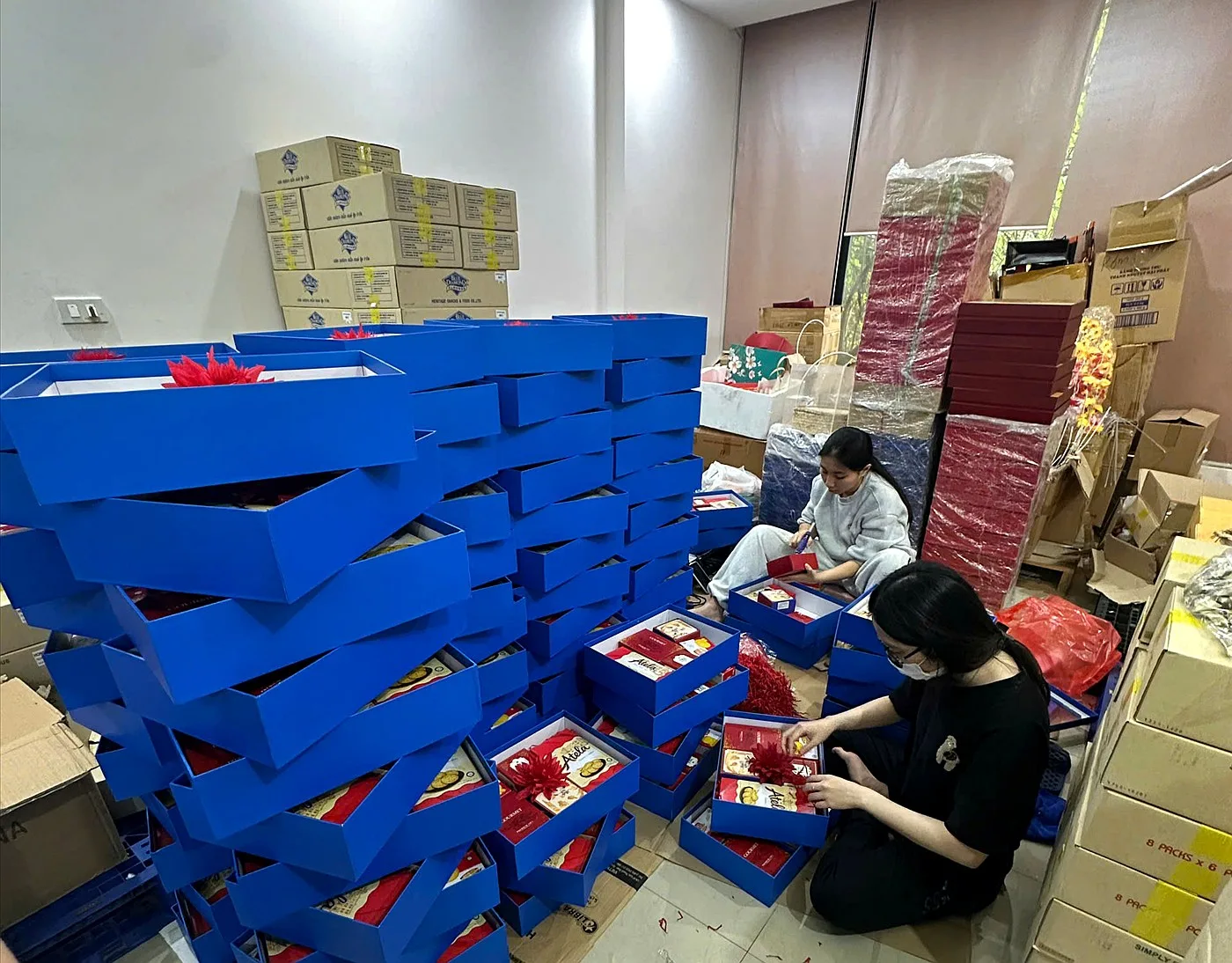 Bulk packing of Tet gift boxes for factory workers at the Now Creative Gifts warehouse