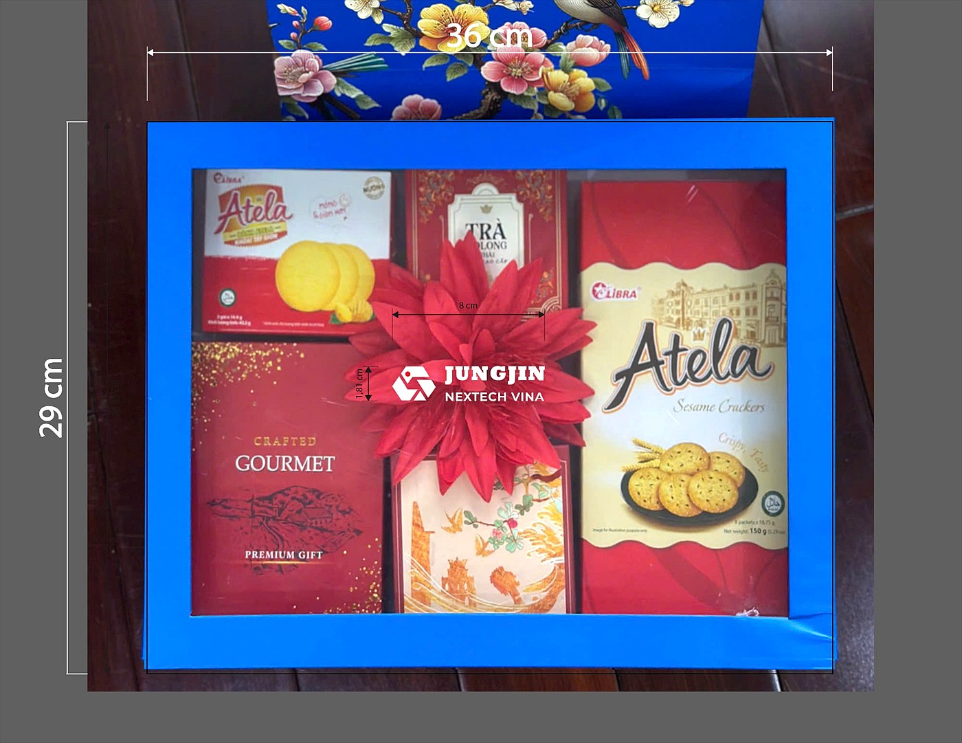Tet gift box with company logo containing biscuits, tea and sweets for factory workers