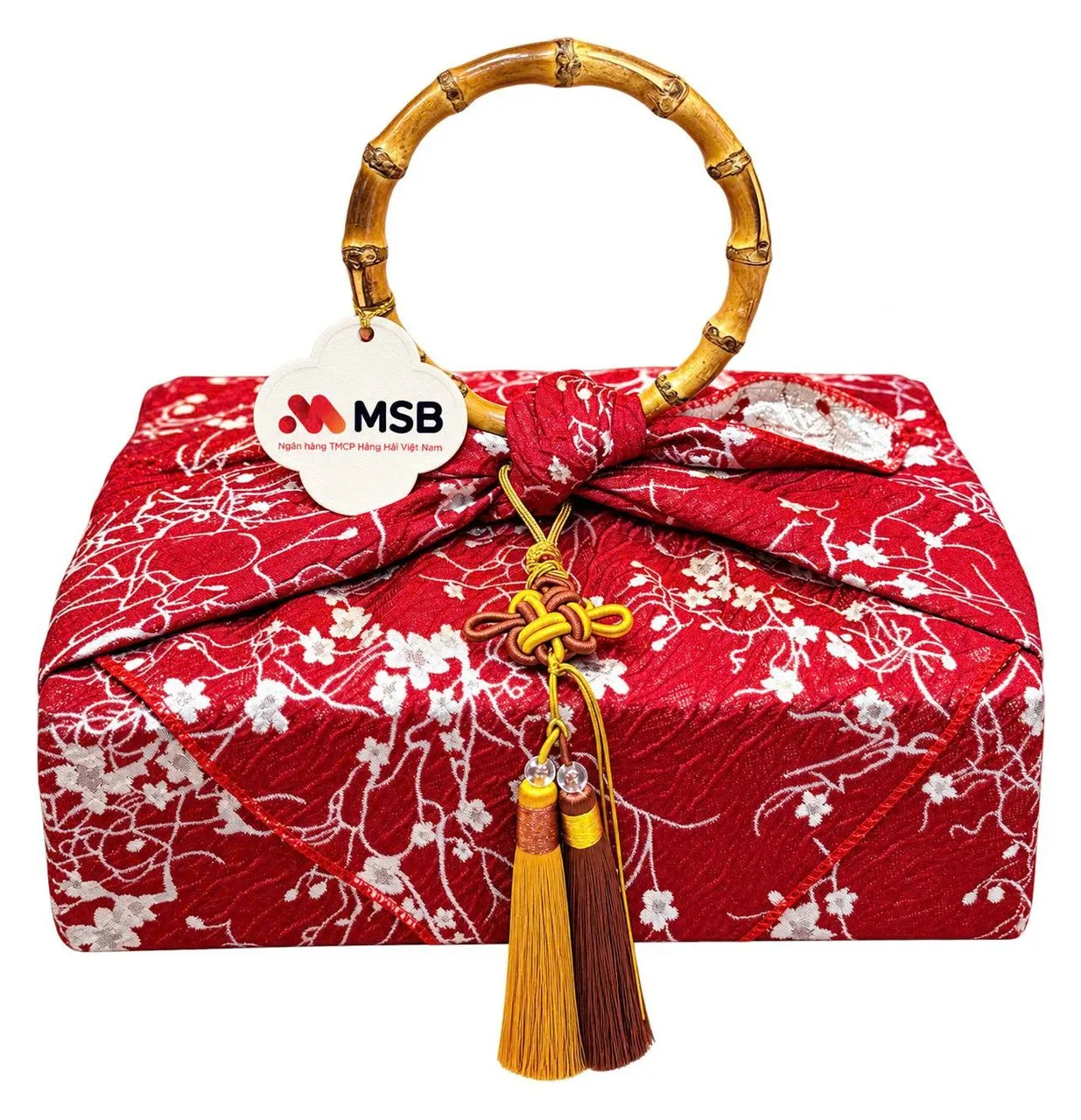 Red fabric-wrapped Tet gift with a bamboo handle, MSB tag and tassels
