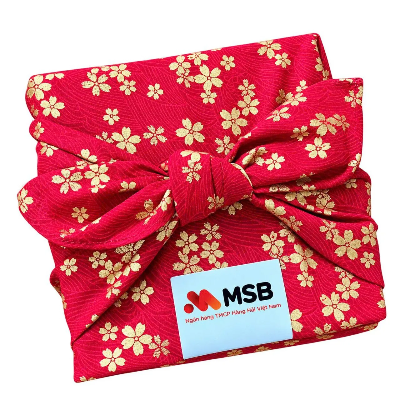 Red fabric-wrapped Tet gift with gold floral pattern and an MSB logo card
