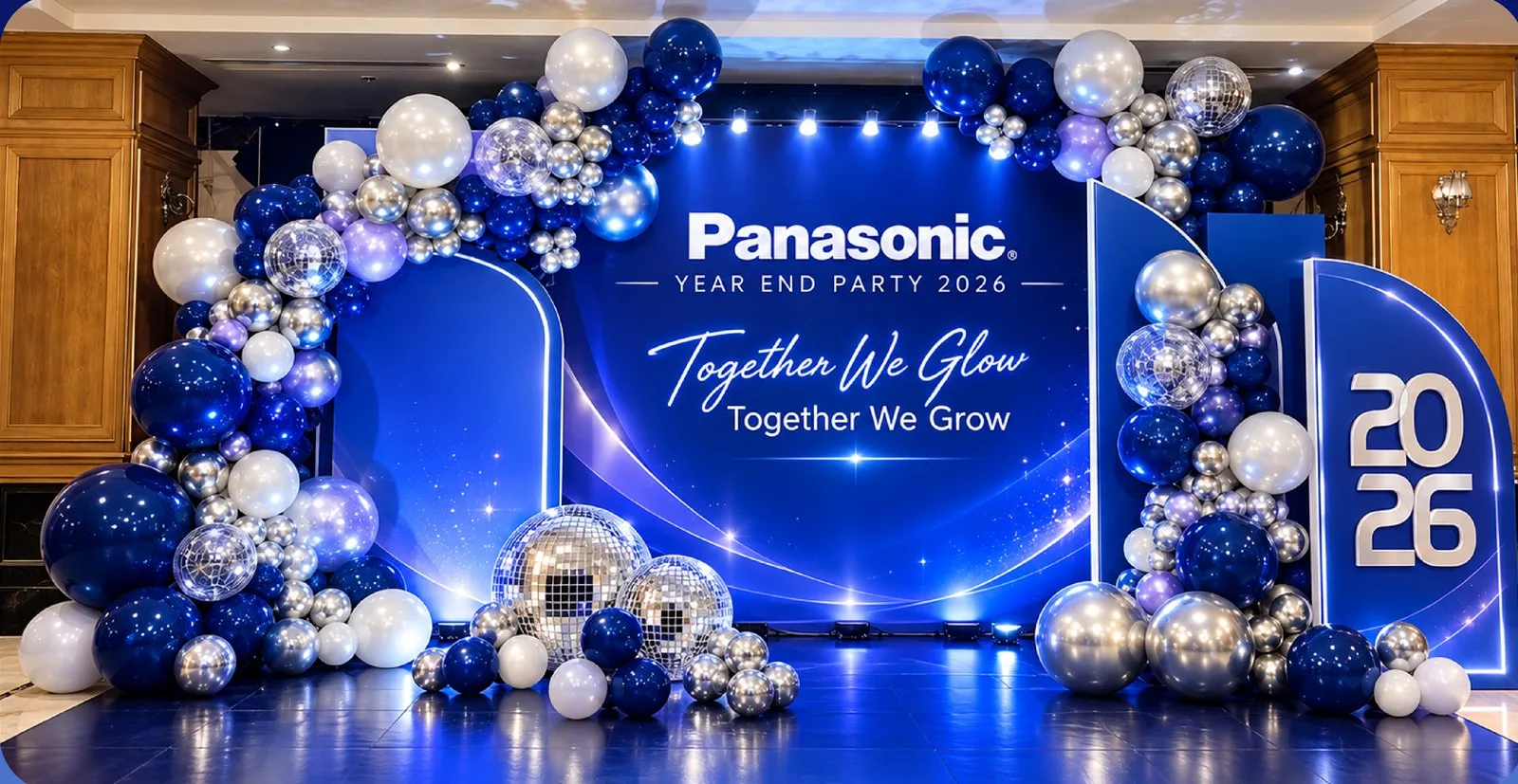 Navy and silver balloon check-in backdrop with the Together We Glow key visual from the Panasonic Year End Party proposal