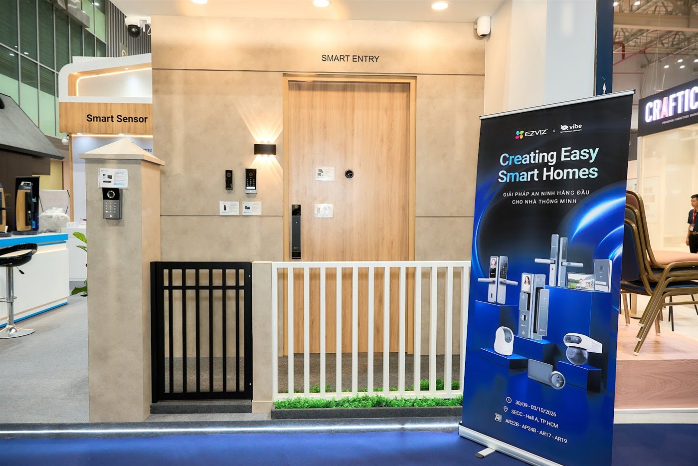 A full home-entrance model with gate, video doorbell, smart lock and camera at the EZVIZ booth.