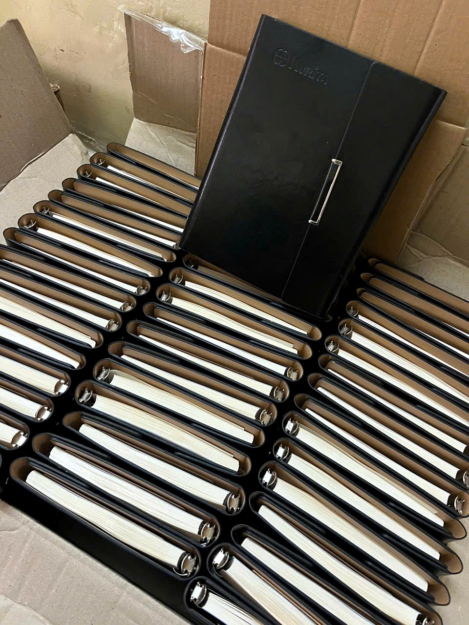 Hundreds of Kurita leather notebooks inspected and packed into cartons before delivery