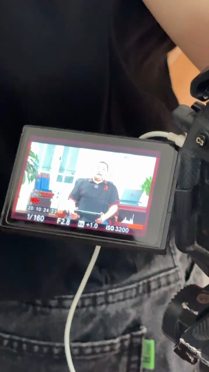 Checking footage on a field monitor during a factory shoot