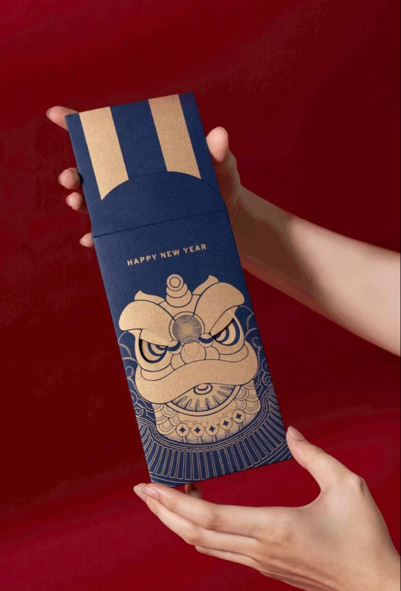 Navy envelope with a lion dance head drawn in bronze lines (collected image)