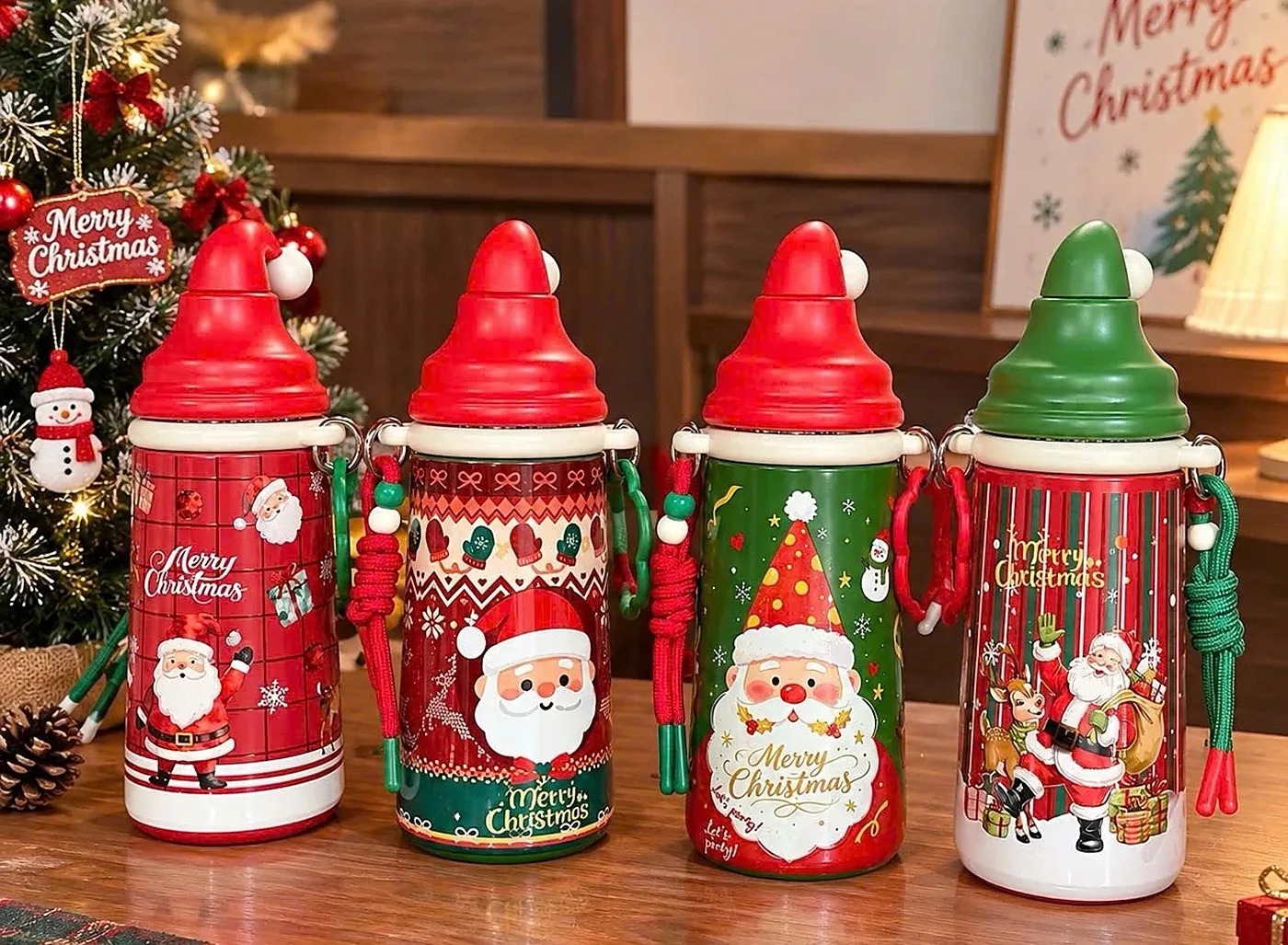 Four insulated bottles with red and green Santa-hat lids and carry straps, printed with Santa designs