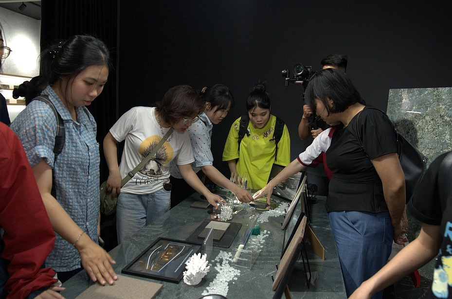 Students examining tile samples and surface finishes in the showroom.